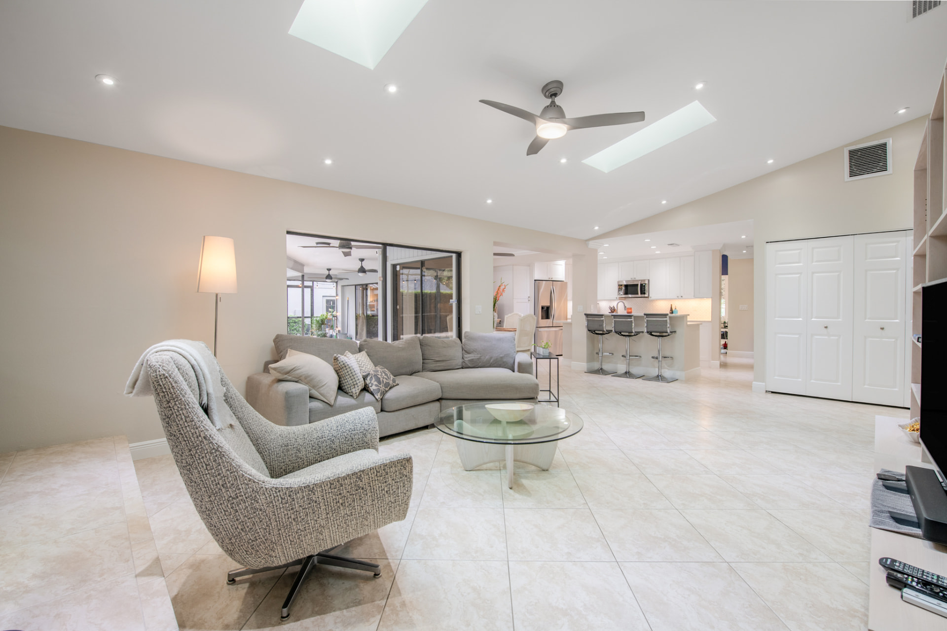 Living room with skylights opening to the kitchen in a Palm Harbor, FL home
