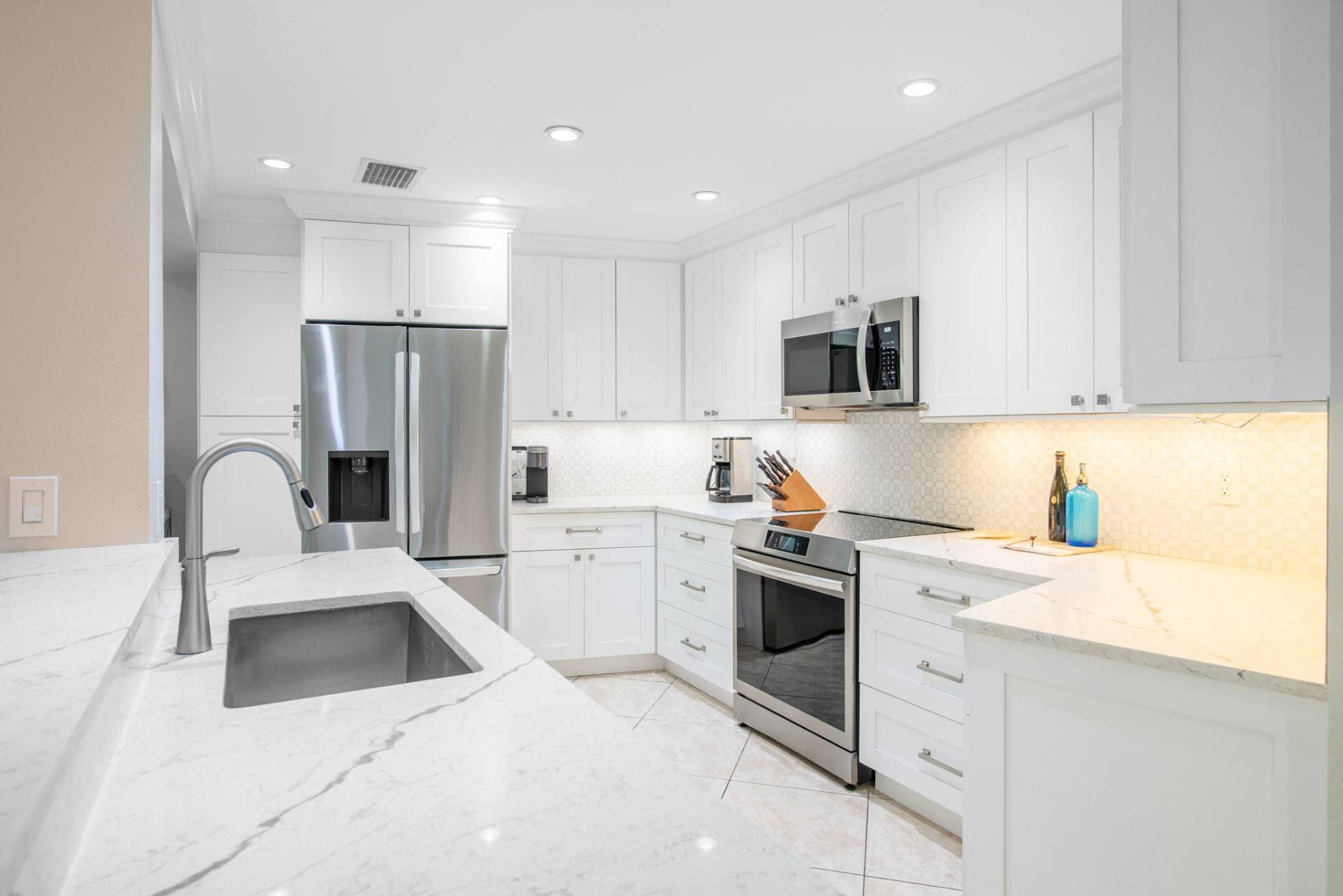 Renovated white kitchen with stainless appliances in a Palm Harbor, FL home