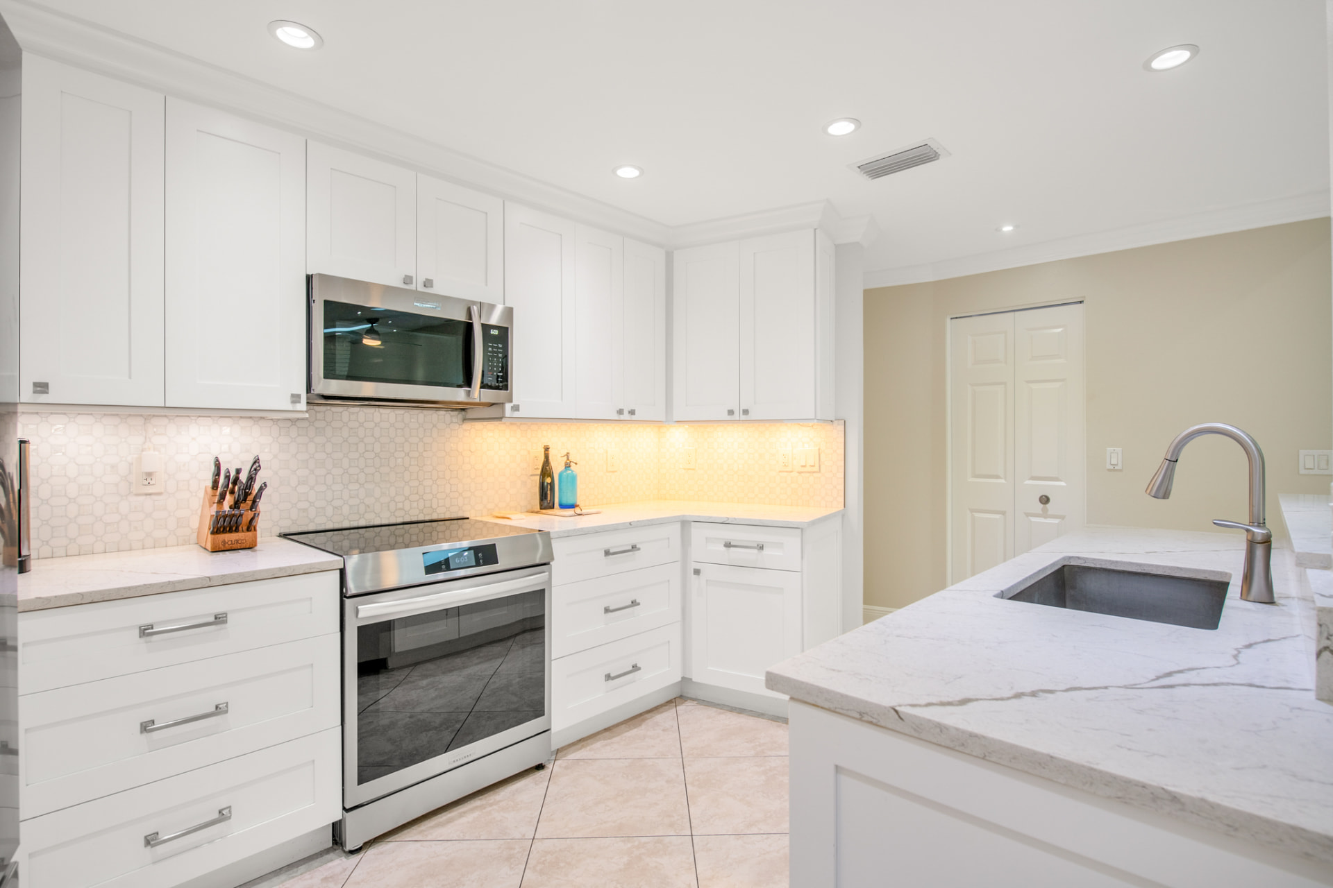 White kitchen with under-cabinet lighting in a Palm Harbor, FL home